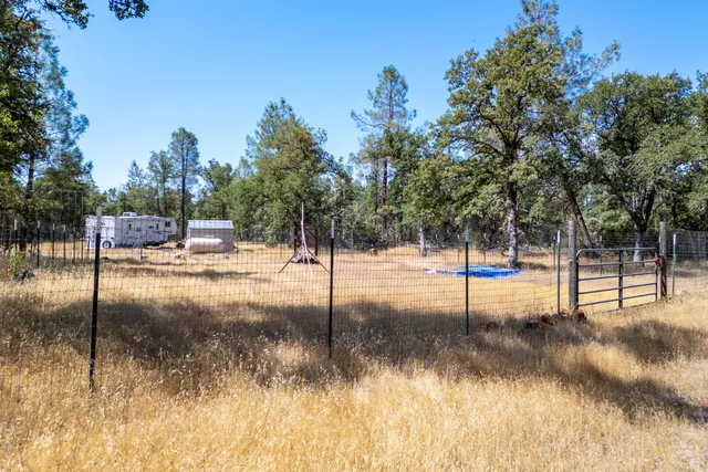 a view of yard covered with snow in front of house