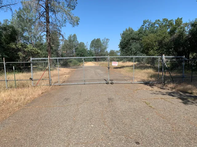 a view of residential house with stairs and trees all around