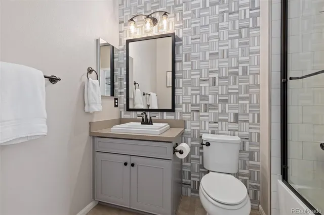 a bedroom with a bed and a desk