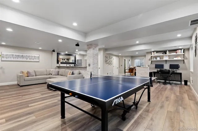 a bathroom with a granite countertop toilet sink and mirror