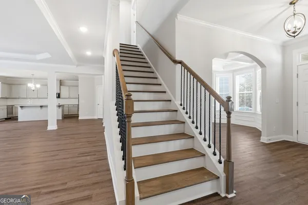 a view of entryway and hall with wooden floor