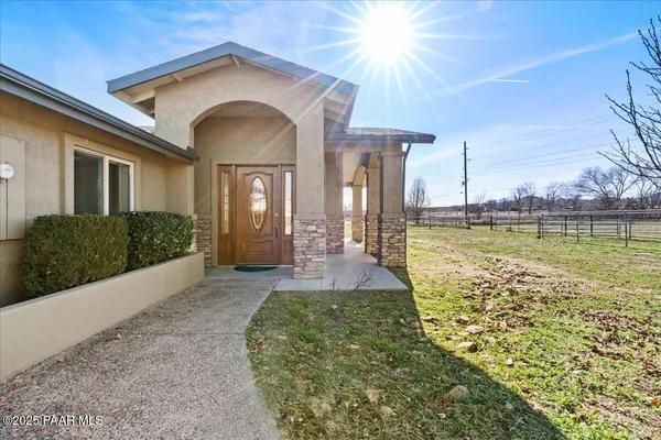 a view of house with backyard and glass windows