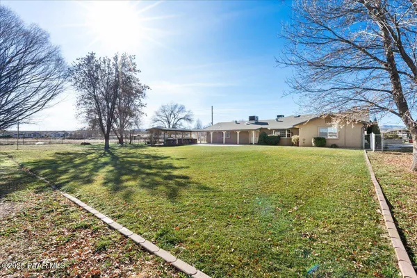 a view of a house with a yard covered in snow