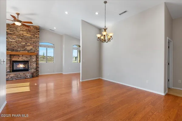 a kitchen with stainless steel appliances kitchen island granite countertop a stove and cabinets