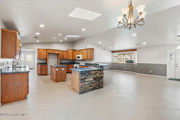 a view of kitchen with stainless steel appliances granite countertop a living room