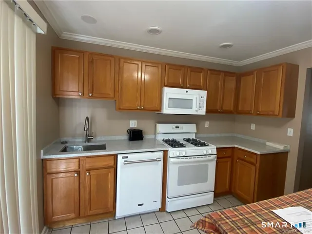 a kitchen with a stove sink and cabinets