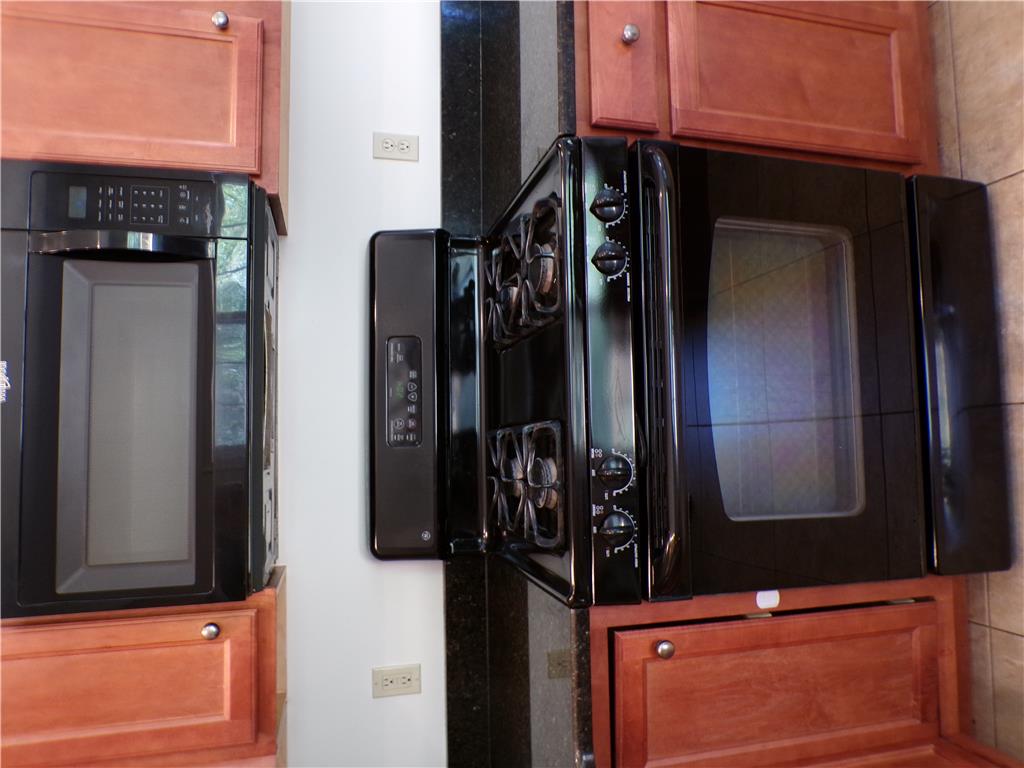 3283 Seip Road Macungie, PA 18062 - Photo 12 of 33 Culinary delights await with a modern range and overhead microwave, all set against rich cabinetry and sleek countertops.
