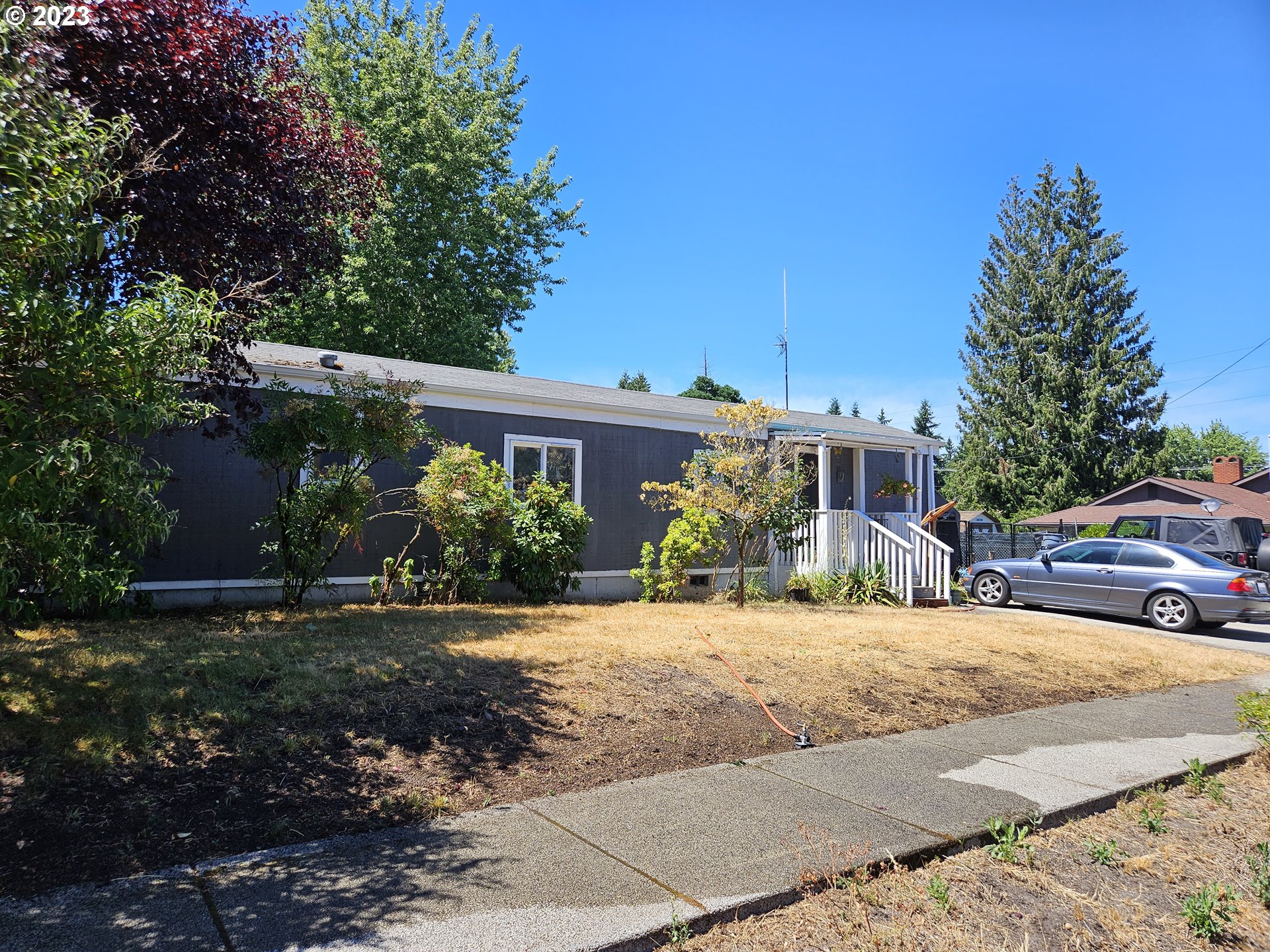 a view of a house with a yard and tree s