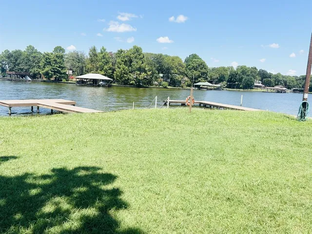 a view of a lake with houses in the background