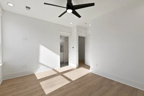 a kitchen with refrigerator cabinets and wooden floor