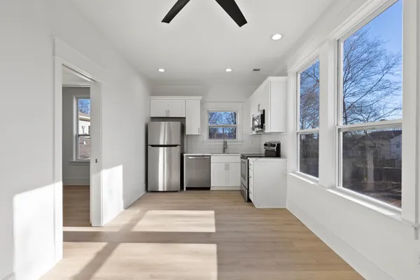 a kitchen with stainless steel appliances a refrigerator sink and microwave