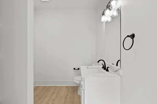 a bathroom with a granite countertop sink a toilet and shower