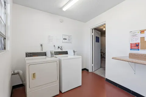 a view of washer and dryer with kitchen in the background