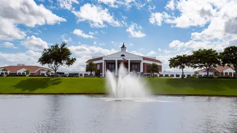 a front view of a house with a garden and yard