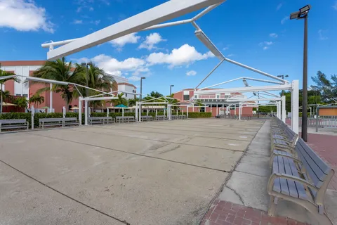 a view of a patio with a table and chairs under an umbrella