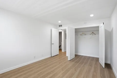 a view of hallway with wooden floor