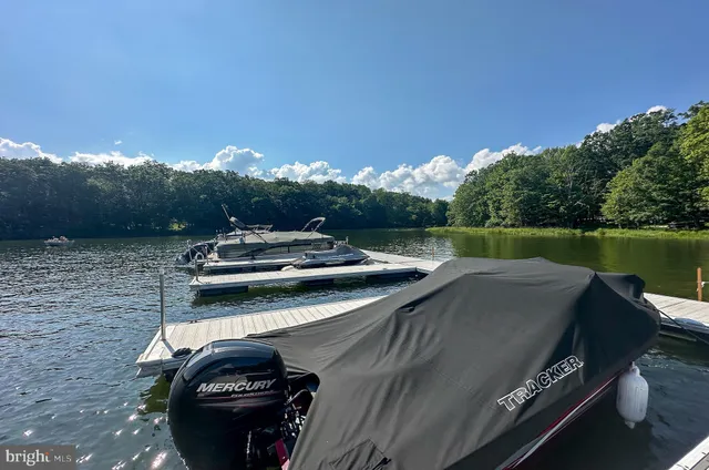 a backyard of a house with trees and outdoor seating