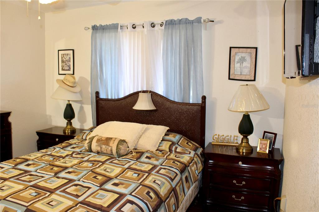 74 Belem Street Punta Gorda, FL 33983 - Photo 15 of 34 a bedroom with a bed window and wall painting