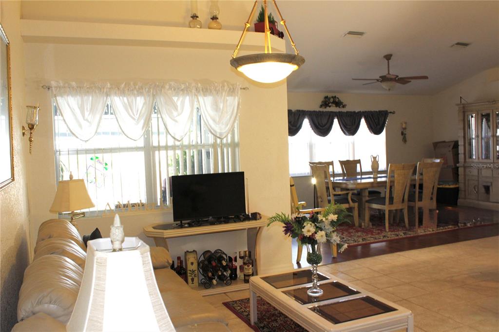 74 Belem Street Punta Gorda, FL 33983 - Photo 19 of 34 a living room with furniture a flat screen tv and a floor to ceiling window