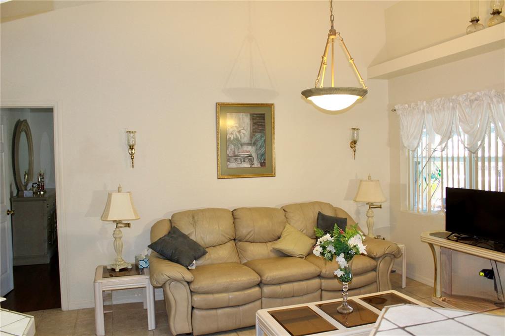 74 Belem Street Punta Gorda, FL 33983 - Photo 20 of 34 a living room with furniture a flat screen tv and a window
