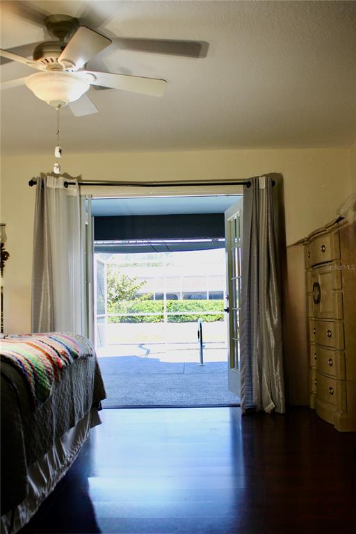 74 Belem Street Punta Gorda, FL 33983 - Photo 25 of 34 a bedroom with a bed and a chandelier