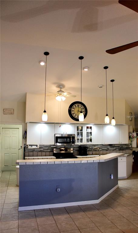 74 Belem Street Punta Gorda, FL 33983 - Photo 3 of 34 a kitchen with stainless steel appliances granite countertop a stove a sink and a wooden floors