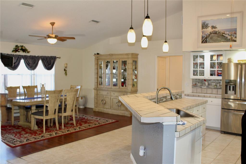 74 Belem Street Punta Gorda, FL 33983 - Photo 4 of 34 a kitchen with a table chairs and a chandelier