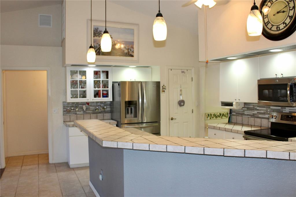 74 Belem Street Punta Gorda, FL 33983 - Photo 5 of 34 a kitchen with stainless steel appliances granite countertop a sink a stove and a refrigerator