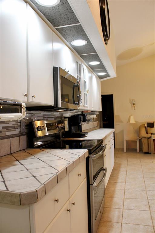 74 Belem Street Punta Gorda, FL 33983 - Photo 6 of 34 a kitchen with stainless steel appliances granite countertop a stove top oven a sink a counter space and cabinets