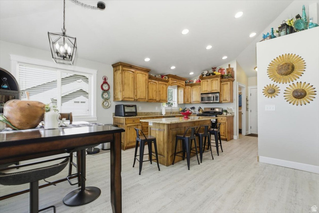 772 East 600 South Preston, ID 83263 - Photo 8 of 35 Kitchen featuring wood cabinetry, light-colored countertops, stainless steel appliances, and wood-finish flooring