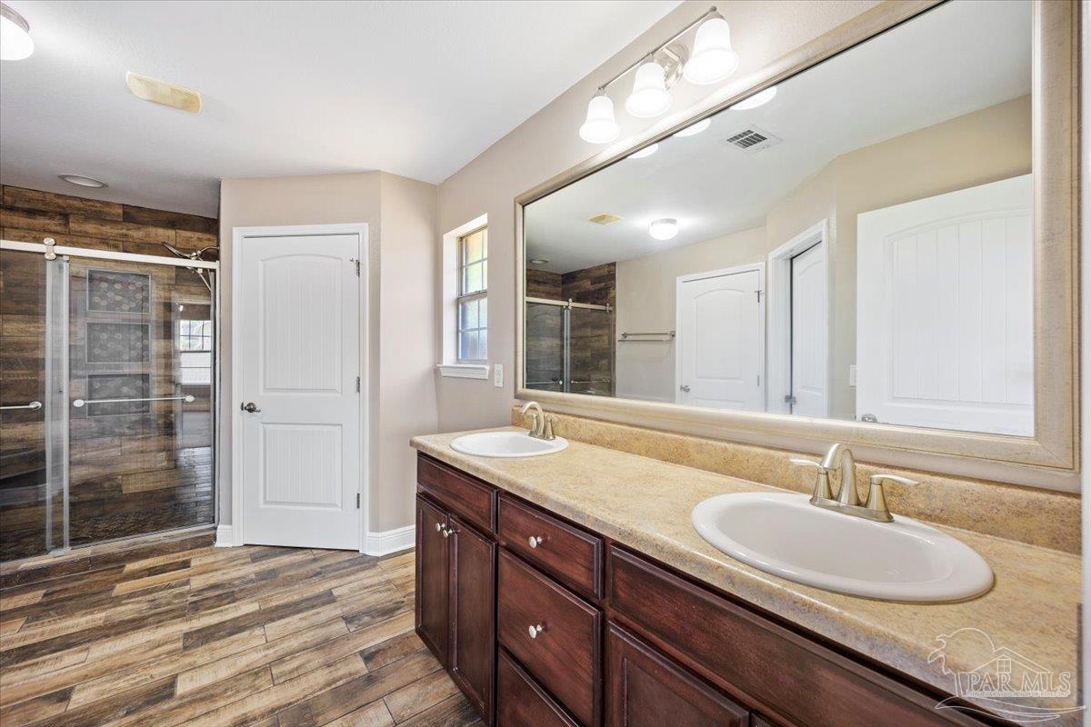 4015 Berry Circle Pace, FL 32571 - Photo 34 of 48 a bathroom with a granite countertop sink and a mirror