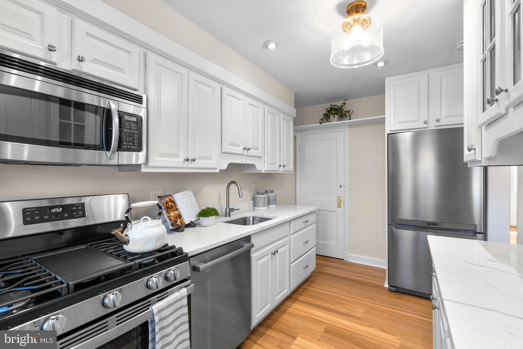 321 Stratford Road Baltimore, MD 21228 - Photo 11 of 34 a kitchen with stainless steel appliances a stove microwave and refrigerator