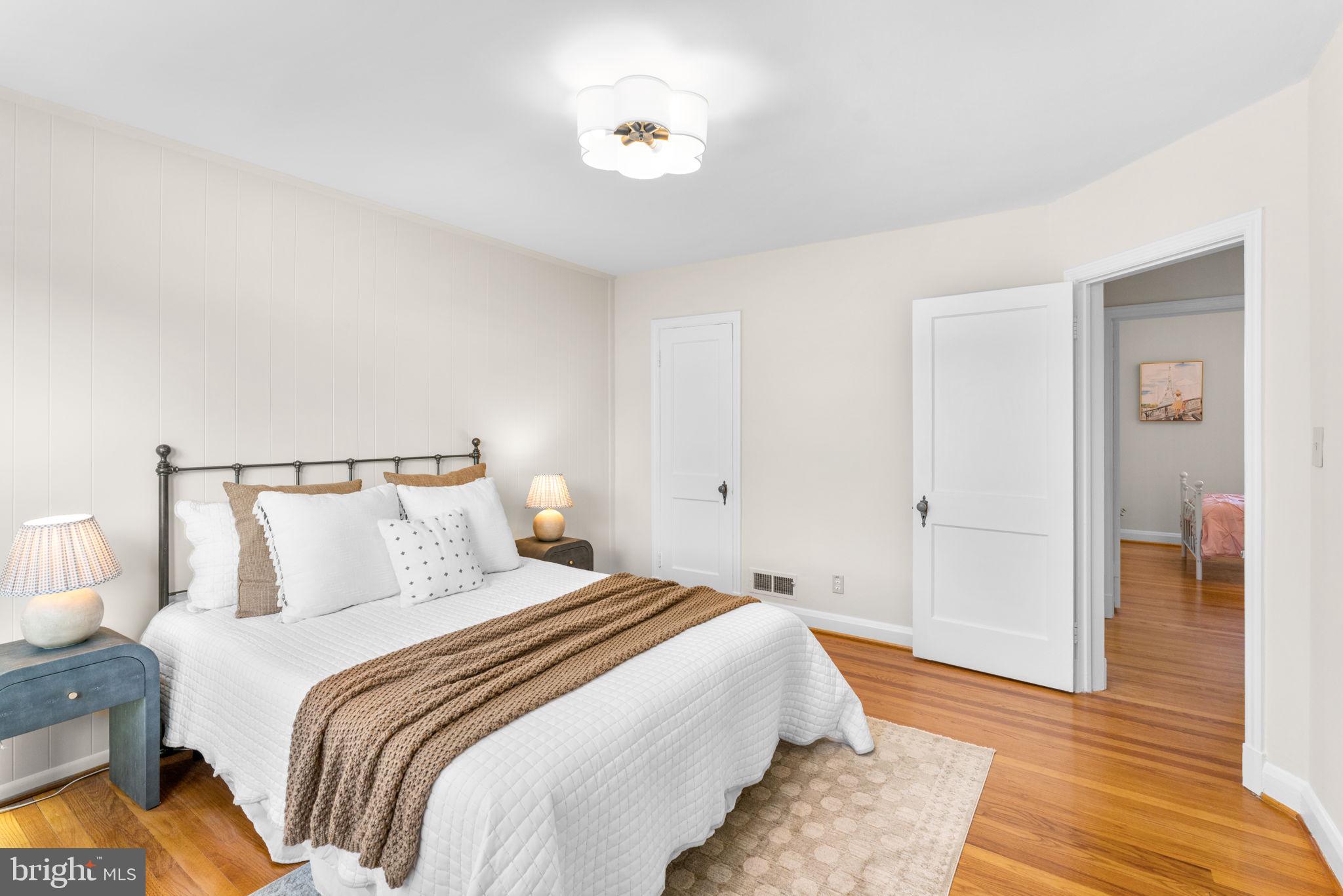 321 Stratford Road Baltimore, MD 21228 - Photo 13 of 34 a bedroom with a bed and wooden floor