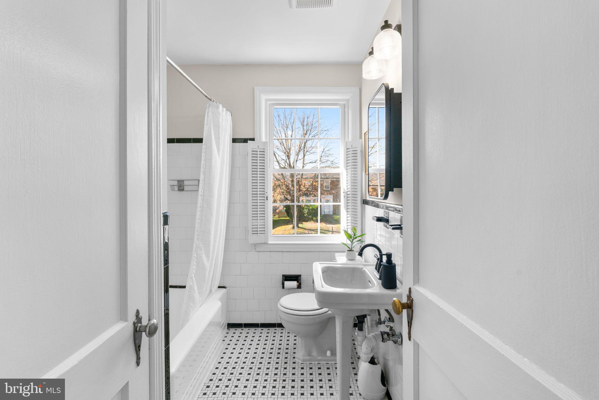 321 Stratford Road Baltimore, MD 21228 - Photo 15 of 34 a bathroom with a sink a toilet and a window