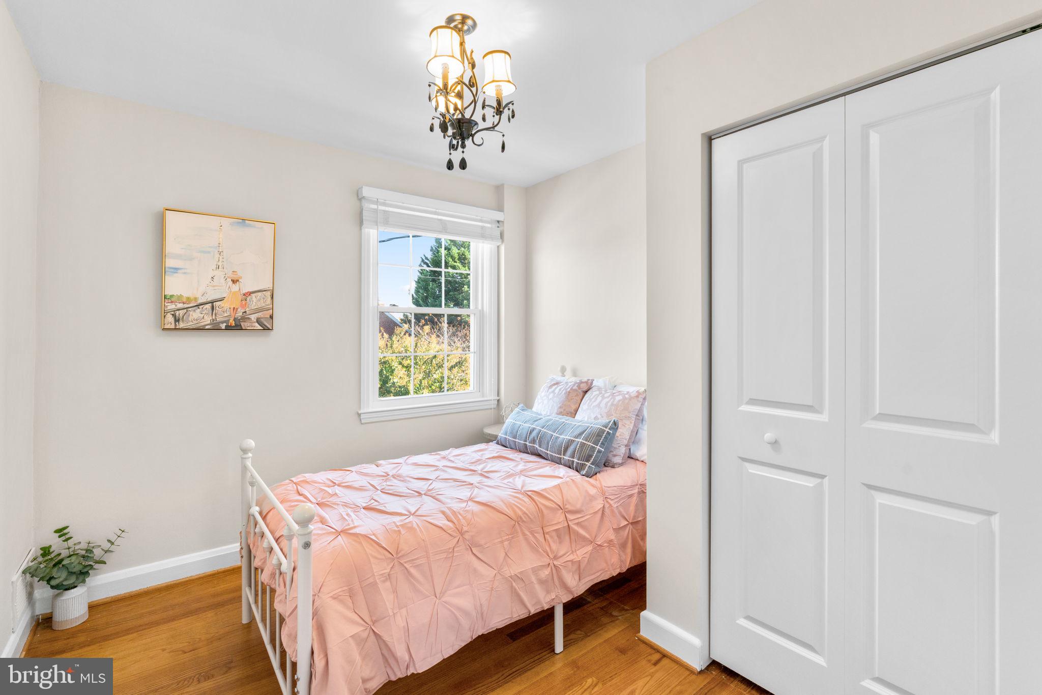 321 Stratford Road Baltimore, MD 21228 - Photo 19 of 34 a bedroom with a bed and a chandelier