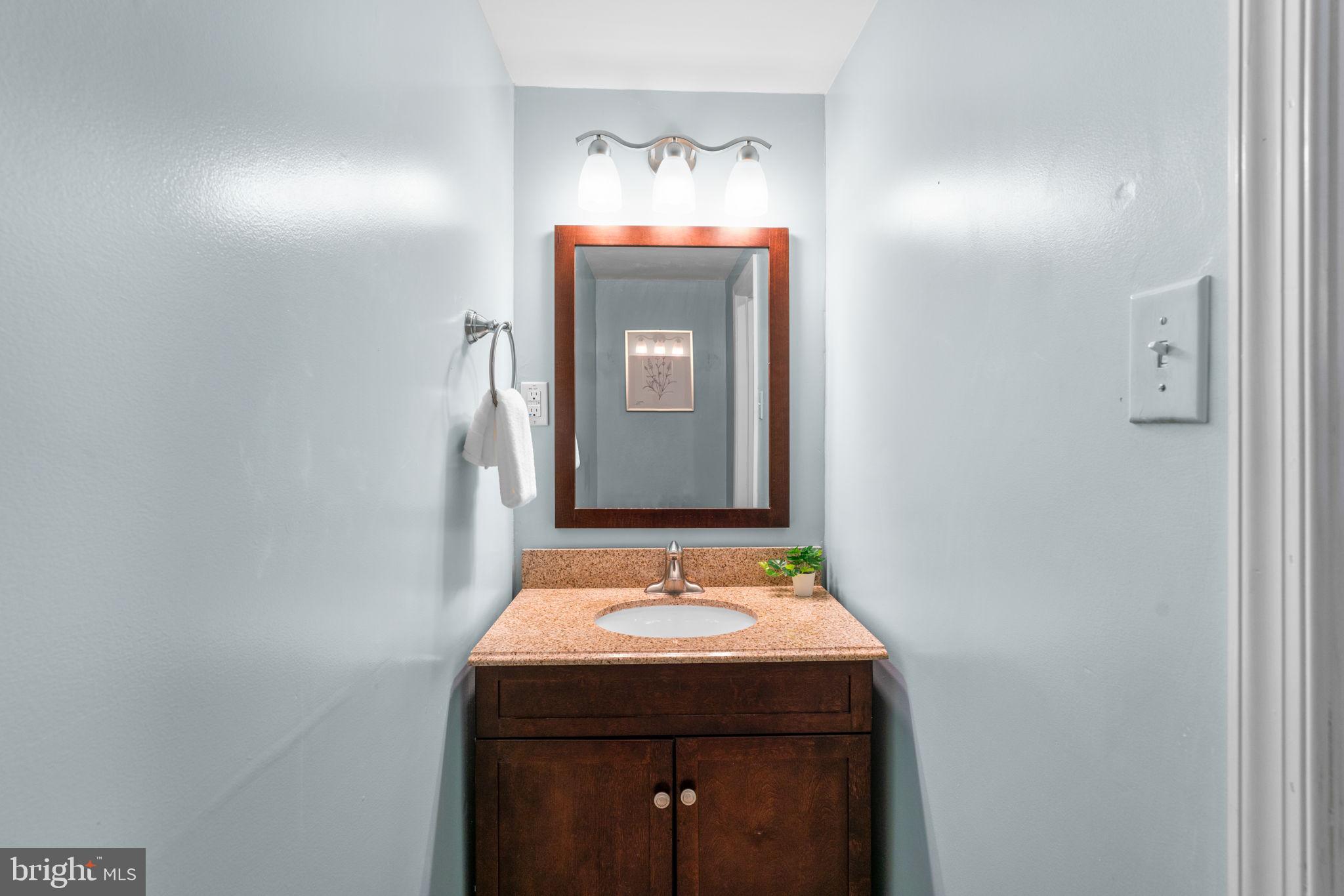 321 Stratford Road Baltimore, MD 21228 - Photo 25 of 34 a bathroom with a sink and a mirror