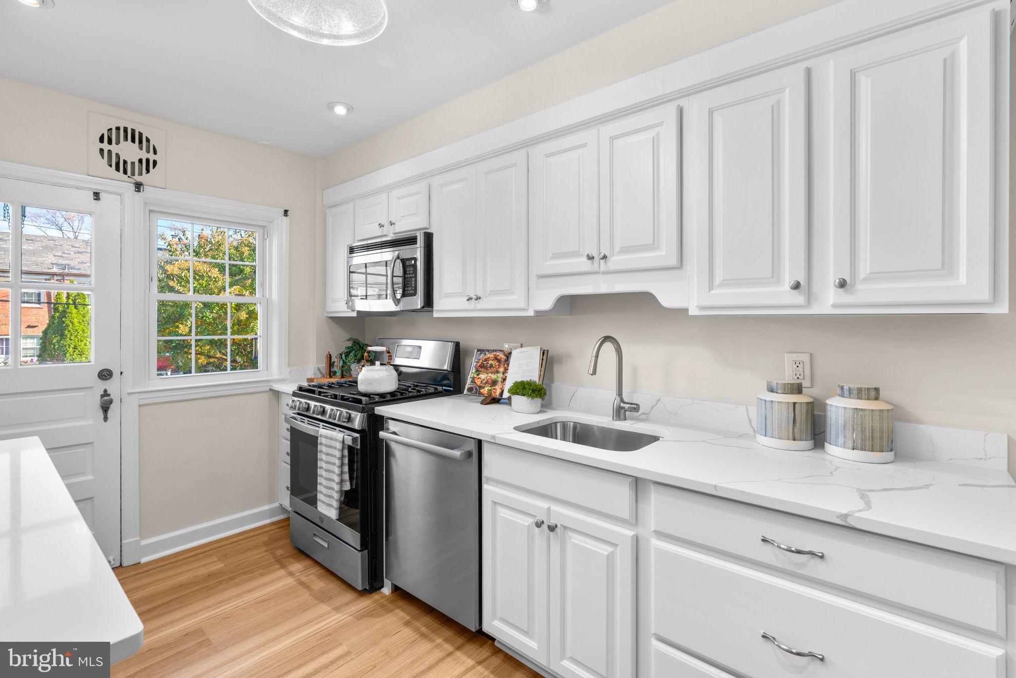 321 Stratford Road Baltimore, MD 21228 - Photo 9 of 34 a kitchen with stainless steel appliances granite countertop a sink stove and cabinets