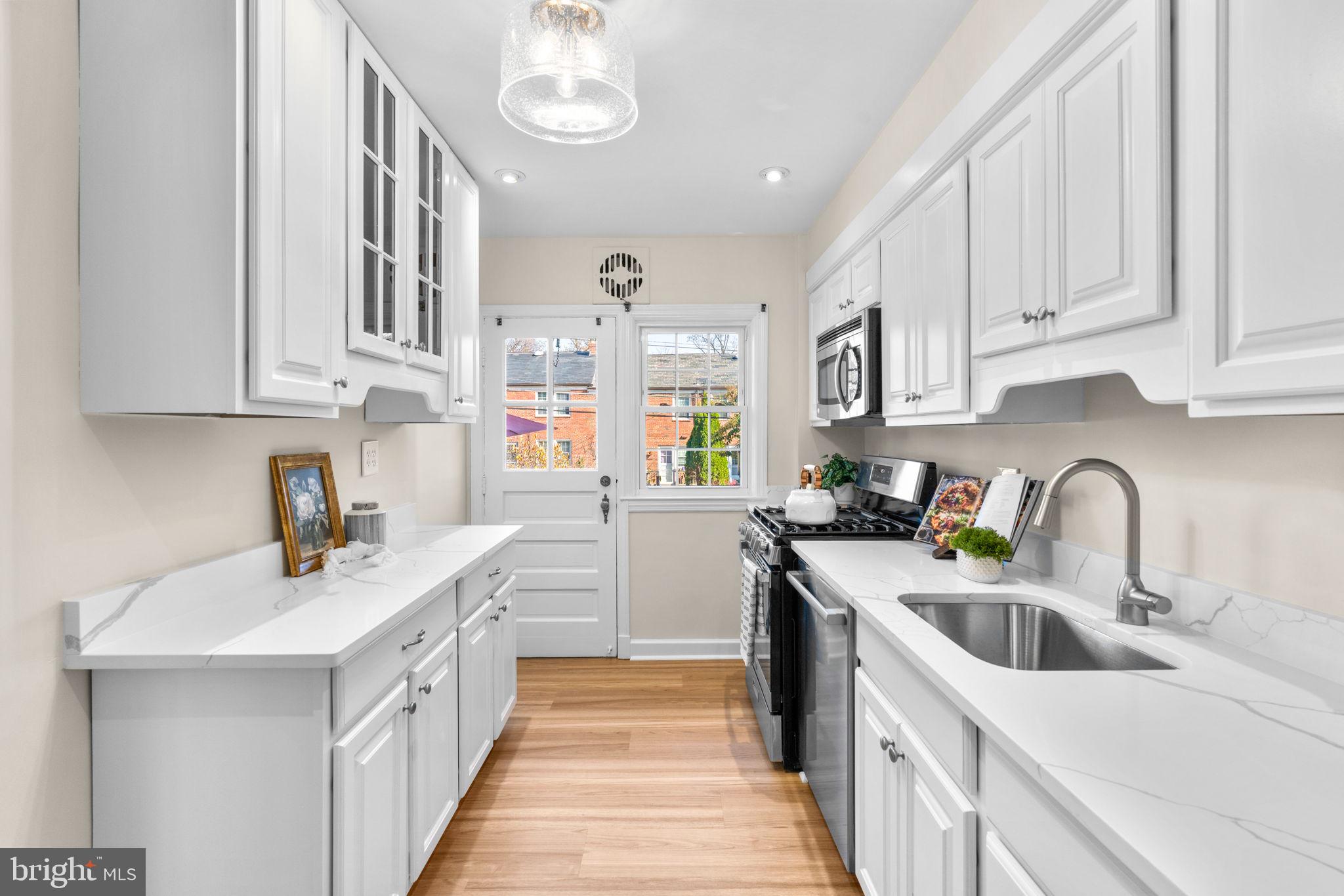 321 Stratford Road Baltimore, MD 21228 - Photo 10 of 34 a kitchen with a sink stove and cabinets