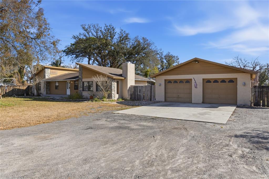 10301 Trail Ridge Lane Tampa, FL 33624 - Photo 1 of 35 a front view of a house with a yard and garage