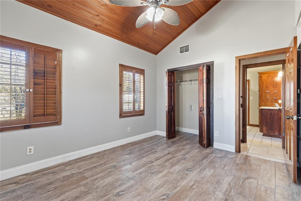 10301 Trail Ridge Lane Tampa, FL 33624 - Photo 15 of 35 a view of an empty room with window and wooden floor