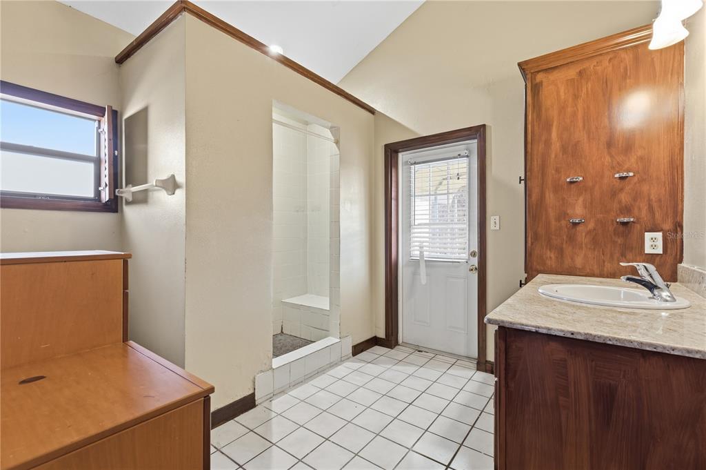 10301 Trail Ridge Lane Tampa, FL 33624 - Photo 18 of 35 a bathroom with a sink and a mirror