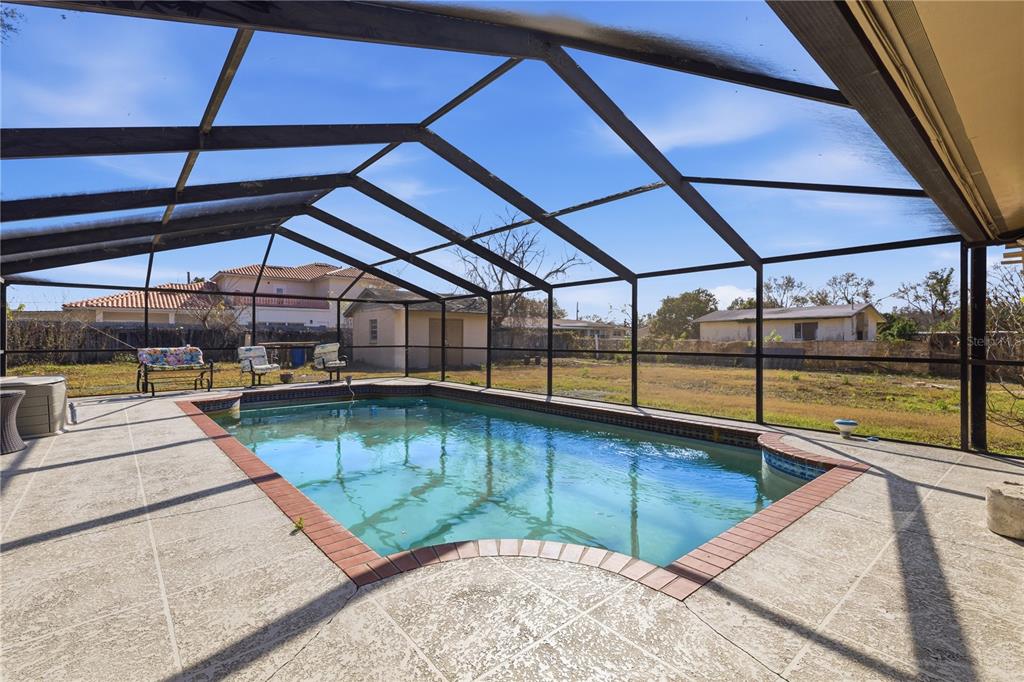10301 Trail Ridge Lane Tampa, FL 33624 - Photo 20 of 35 a view of a swimming pool with a porch