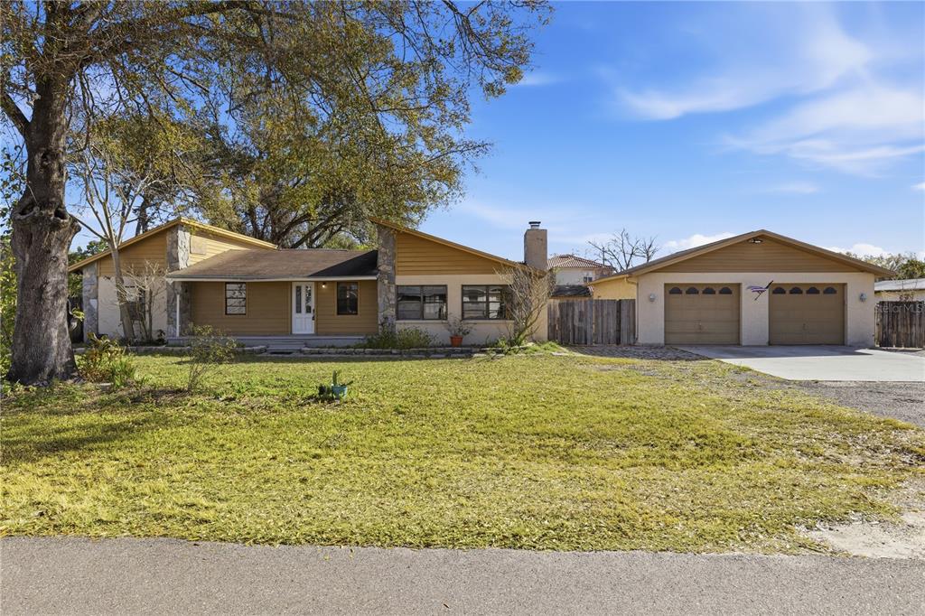 10301 Trail Ridge Lane Tampa, FL 33624 - Photo 2 of 35 a front view of a house with a yard