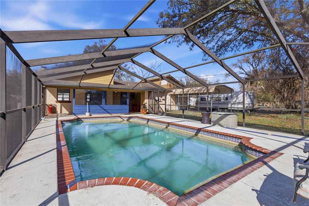 10301 Trail Ridge Lane Tampa, FL 33624 - Photo 21 of 35 a view of a swimming pool with a patio