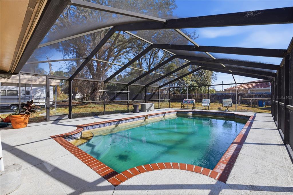 10301 Trail Ridge Lane Tampa, FL 33624 - Photo 22 of 35 a view of a swimming pool with a patio