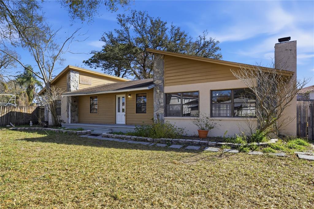 10301 Trail Ridge Lane Tampa, FL 33624 - Photo 3 of 35 a view of a house with a yard