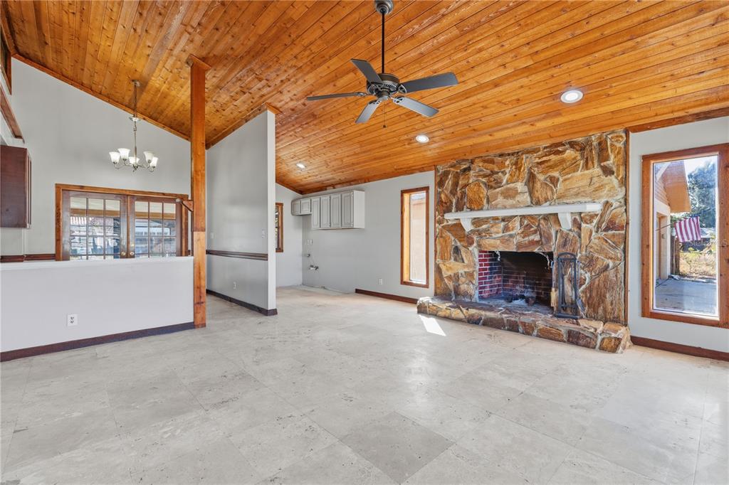 10301 Trail Ridge Lane Tampa, FL 33624 - Photo 4 of 35 an empty room with fireplace and windows