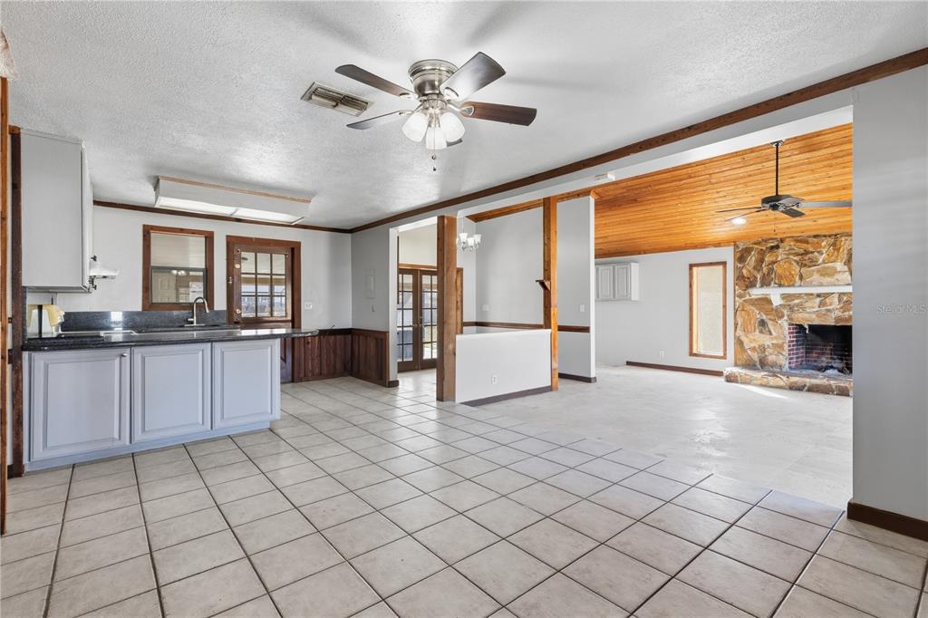 10301 Trail Ridge Lane Tampa, FL 33624 - Photo 5 of 35 a large white kitchen with granite countertop a large window and a counter top space