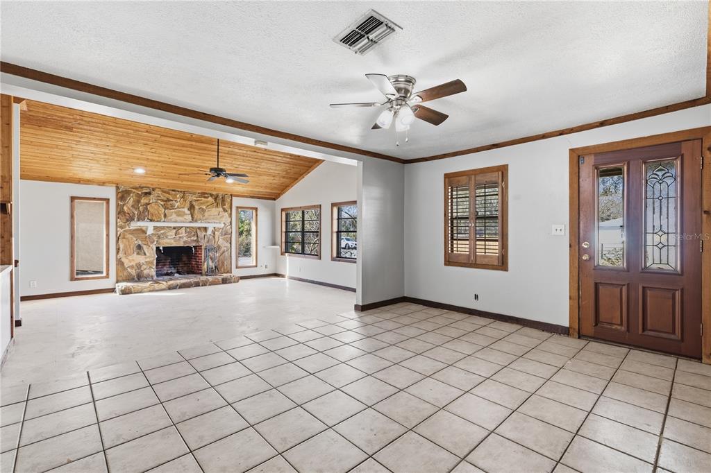 10301 Trail Ridge Lane Tampa, FL 33624 - Photo 6 of 35 a view of an empty room with window and chandelier fan