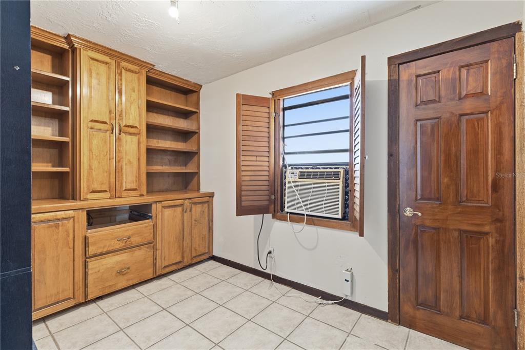 10301 Trail Ridge Lane Tampa, FL 33624 - Photo 7 of 35 a view of an empty room with cabinet and windows